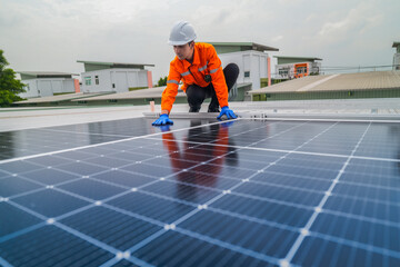 A worker in an orange safety jacket inspects solar panels on a rooftop, using a laptop to ensure proper maintenance. The scene highlights renewable energy, solar technology, and sustainable practices.