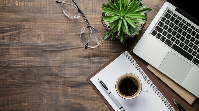 Work from home. desk office with laptop, blank notepad, coffee cup and pen on wood table. Flat lay top view copy space. - Powered by Adobe