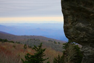 Scenic view of the Blue Ridge Mountains with a rocky outcrop in the foreground under a cloudy sky