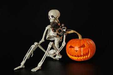 Tarantula on pumpkin. Spider isolated on black background. Skeleton and animal. Halloween holiday concept