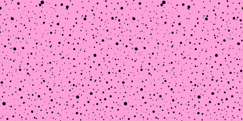 Pink ink splatter seamless pattern on a pink backdrop. Abstract spray grunge texture. Features scattered black dots with a speckled texture. Black explosion of paints. Hand drawn rose pastel backdrop.