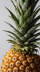 Fototapeta premium Organic ripe pineapple captured in a bright studio setting, highlighting its natural golden and green hues