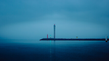 A serene seascape featuring a misty harbor