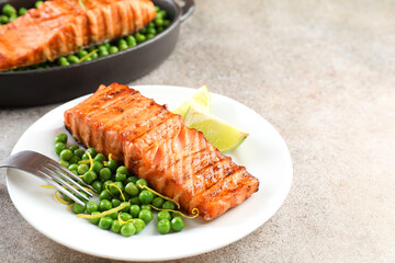 Delicious grilled salmon fillets served on grey textured table