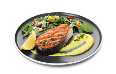 Tasty grilled salmon steak with lemon, sauce and salad isolated on white