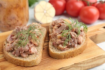 Sandwiches with canned meat and dill on table, closeup