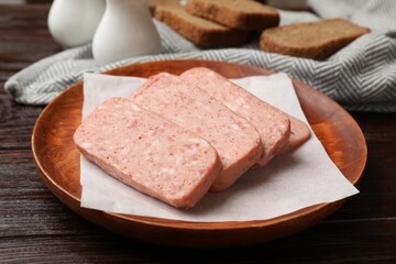 Canned meat and bread on wooden table, closeup