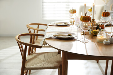 Stylish dining room with beautiful table setting and autumn decor