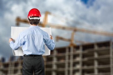 Two Architect worker discussing building plan at construction site