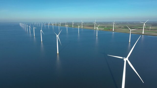 Offshore wind farm at sea and on shore. Aerial view of Windpark with wind turbines, windmills in Netherlands. Power plant, climate change, sustainable resources, green renewable energy. 4K