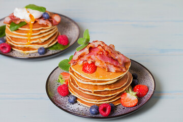 Stack of pancakes  with savory topping and berries at breakfast