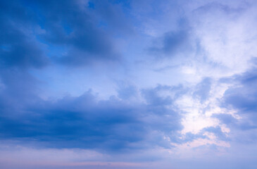 Clouds and blue sky background,blue sky background with tiny clouds,clear blue sky with a few clouds. The sky is very bright and the clouds are scattered throughout