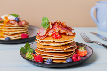 Stack of pancakes  with savory topping and berries at breakfast
