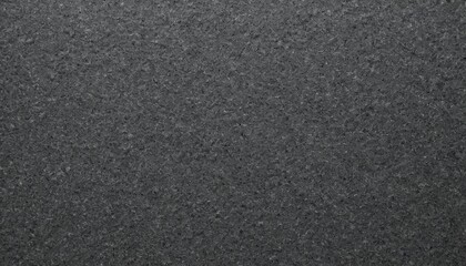 Dark textured sandpaper surface background with coarse finish