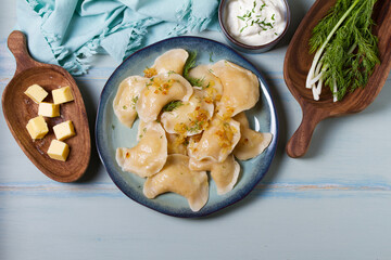 Dumplings filled with mashed potatoes. Varenyky, vareniki, pierogi, pyrohy - dumplings with filling. View from above, top studio shot