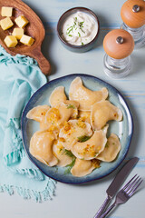 Dumplings filled with mashed potatoes. Varenyky, vareniki, pierogi, pyrohy - dumplings with filling. View from above, top studio shot