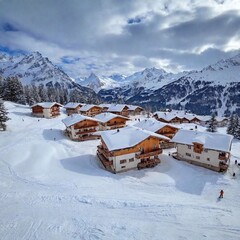 A picturesque ski resort nestled in the mountains, with snow-covered chalets