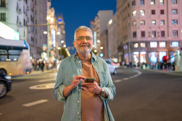 Nighttime scene captures man gazing calmly with vibrant urban background of lights and motion