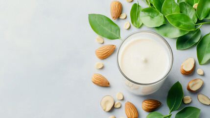Almond milk pouring into a glass, surrounded by fresh almonds and green leaves, emphasizing natural, plantbased nutrition