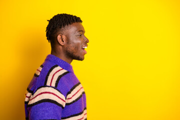 Profile photo of nice young man open mouth empty space wear pullover isolated on yellow color...