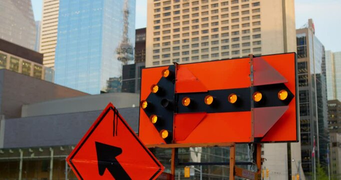 Urban roadwork scene with bright warning signs and traffic detours showcases vibrant city life, emphasizing navigation and safety in the midst of dynamic downtown construction projects.