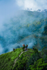 Exploring nature trails with adventurers scenic mountain range outdoor activity foggy environment aerial view adventure spirit