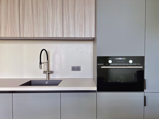 a kitchen sink with a faucet and a faucet. Explore modern and space-saving condo apartment kitchen designs. Perfect for small apartments, these photos showcase stylish kitchen cabinets and innovative 