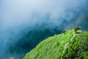 Hiking adventure with friends scenic mountain hill nature exploration cloudy environment panoramic view outdoor fun