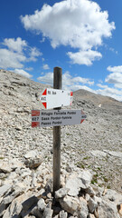 arrows indicating the direction to follow to reach the mountain resorts and alpine refuges in the Italian mountains