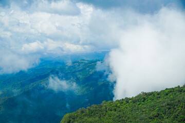 Breathtaking cloud-covered mountain landscape nature reserve aerial view lush greenery adventure and tranquility