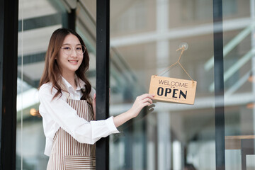 A shopkeeper flipping an open sign at the storefront, letting customers know the shop is now open. The scene highlights the start of a welcoming and professional business day in a retail or cafe.