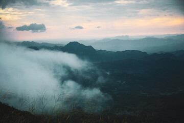 Mountain fog rolling over valleys at sunrise nature landscape scenic viewpoint serene environment atmospheric conditions