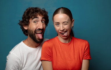 with cheerful, carefree, rebellious attitude, joking and sticking tongue out, having fun