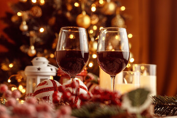 Festive red wine glass surrounded by Christmas decorations, creating a cozy holiday vibe. Perfect for Christmas, holiday season, festive celebrations, winter drinks, seasonal parties and holiday cheer
