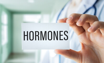 Book with words hormones imbalance on a table in hands doctor.