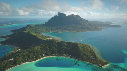 Breathtaking aerial perspective of Bora Bora exotic island, French Polynesia, mount Otemanu in background, vibrant green landscapes, crystal-clear blue waters coral reef. A perfect tropical haven
