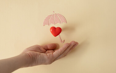 Hands holding red heart, health care, hope, life insurance concept, world heart day, world health...