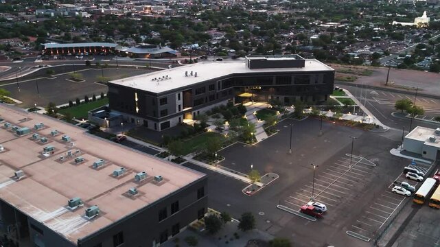 view of Dixie Technical College with front parking lot, and a background of St George city in Utah