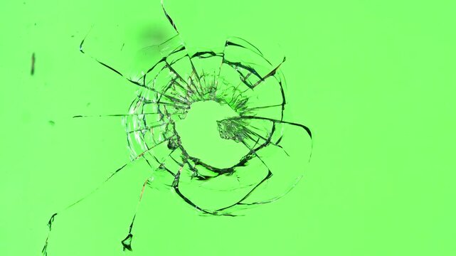 Super Slow Motion of Shattered Glass Isolated on Green Background. Break Glass from the Gunshot. Filmed on High Speed Cinema Camera, 1000 fps.