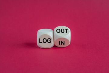 Turned a cube and changes the expression Login to Logout. Beautiful pink background, grey table. Business concept.
