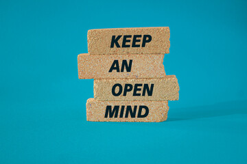 Keep an open mind symbol. Brick blocks with words Keep an open mind. Beautiful blue background. Business and Keep an open mind concept. Concept word