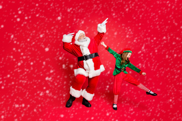 Full size photo of excited santa claus and elf in hat with eyeglasses eyewear dancing fooling...