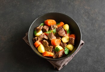 Beef stew with potatoes, carrots and greens
