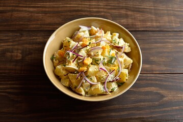 Warm potato salad with egg, pickle, red onion with mayonnaise an