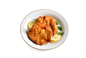 Schnitzel served with lemon and leaves of parsley