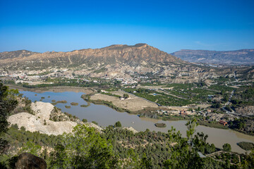 Obraz premium Panoramic view of the Ojós reservoir, in the Ricote Valley, Region of Murcia, Spain, with the town of Blanca in the background