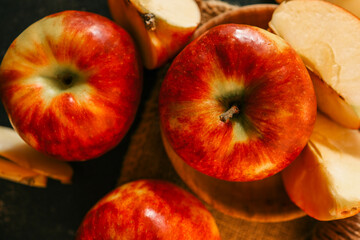 Close-up of vibrant red apples against a matching red background, highlighting their texture, color, and natural freshness in a bold, minimalistic composition