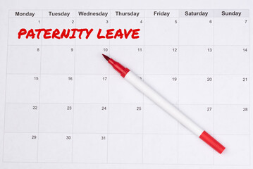 Monthly calendar with the note "Paternity Leave," concept of planning for parental leave, fatherhood, and family time. Preparation for the arrival of a baby and shared parenting responsibilities.
