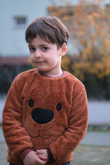 Portrait of a shy little boy on a sunny autumn day.