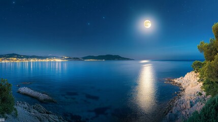 Fototapeta premium Picturesque panorama with full moon on the sea at night.